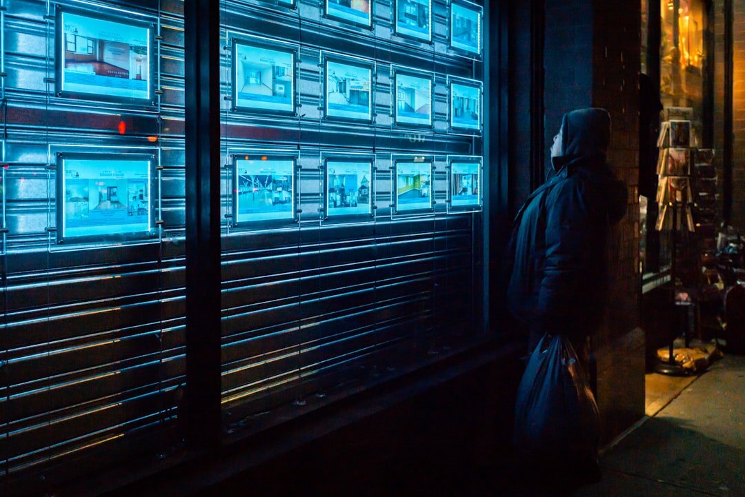 Technician monitoring a wall of live video feed screens
